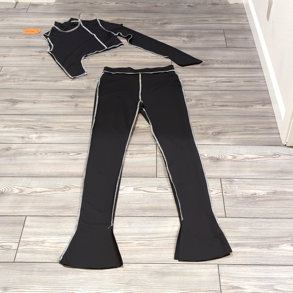 Black pants and top with white stitching. New, never worn.